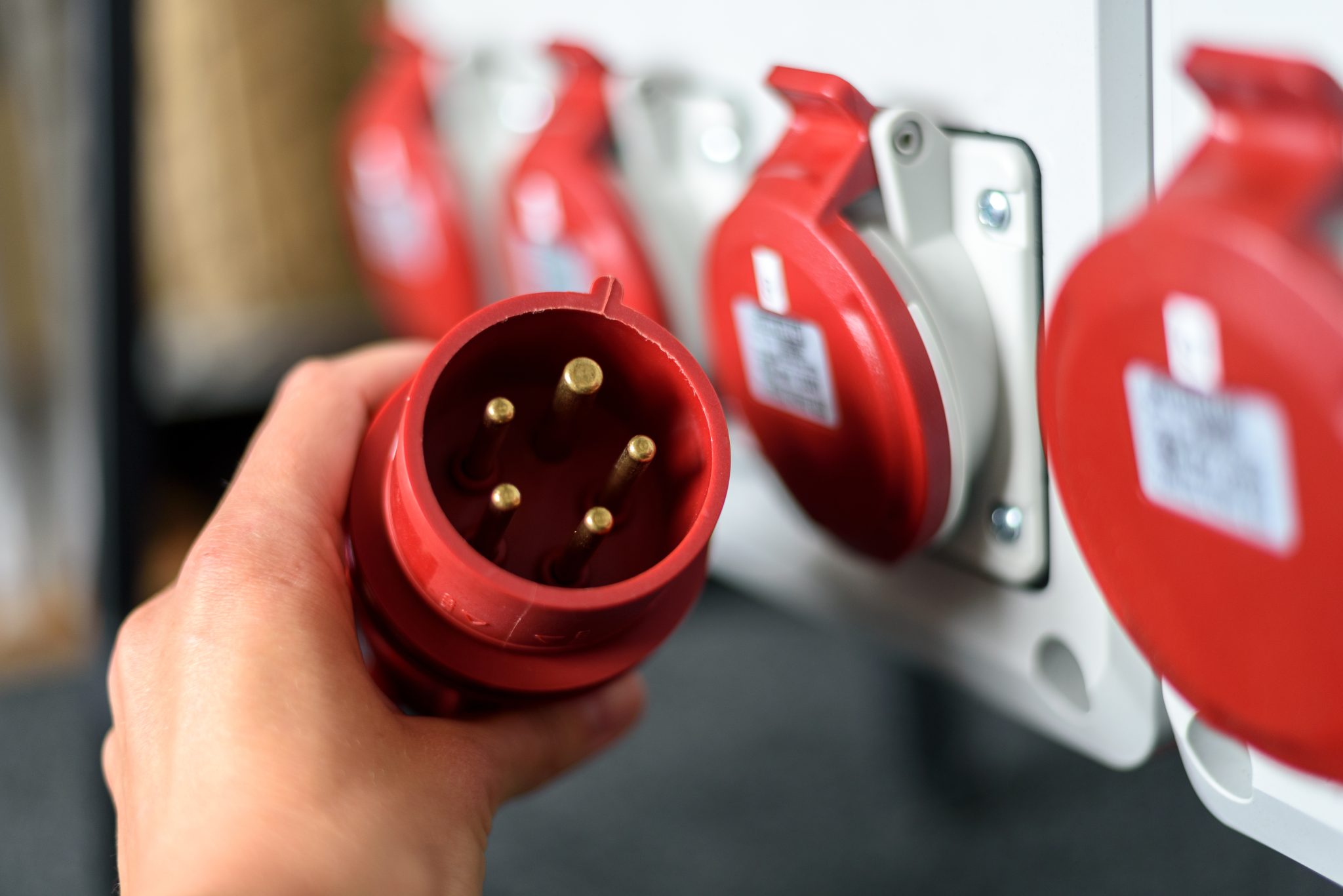 Industrial sockets and plug on distribution board. Construction site electricity, temporary energy supply